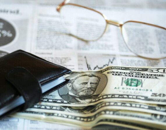 Money together with a wallet and eyeglasses